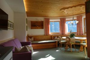 a living room with a couch and a table and chairs at Apart Stotter in Kappl