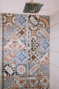a bathroom with colorful tiles on the wall at MODERN ELEGANCE SUITE B&B in Larino +12 photos