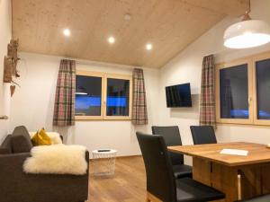 a living room with a table and a dining room at Woodpecker Chalets in Klösterle am Arlberg