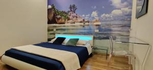 a bedroom with a bed with a painting on the wall at I Due Grifoni Apartments in Taormina
