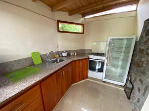 a kitchen with a sink and a stove at Galapagos Dove in Puerto Ayora