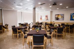 a dining room with black tables and chairs at Hotel Salvevir in Ejea de los Caballeros