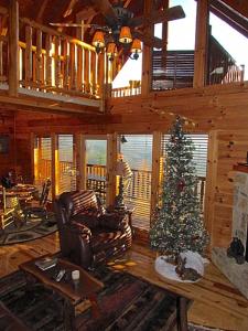 a living room with a christmas tree in a cabin at #1850 Amazing Smoky Views in Williamsburg