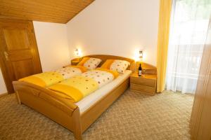 a bedroom with a bed with yellow pillows and a window at Home in the Alps in Racines