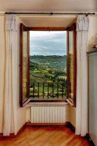 a room with a large window with a view at Ripa Medici, camere con vista e parcheggio incluso in Orvieto