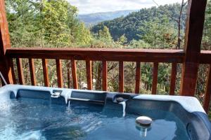 a hot tub on the deck of a cabin with a view at #2168 A View for Two in Dupont Springs