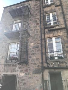 a brick building with balconies and fire escapes on it at Merchant House in Kirkcaldy