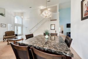 a kitchen and dining room with a marble table and chairs at 4 Corners Getaway in Davenport