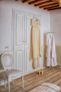 a room with a closet with a dress and a chair at La Casa Bianca with parking and view in Orvieto