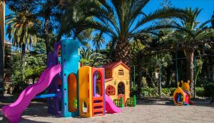 a playground with a toy house and a slide at Residenza Abbo in Diano Marina