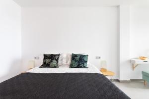 Posteľ alebo postele v izbe v ubytovaní Apartamentos Las Terrazas de Sotavento