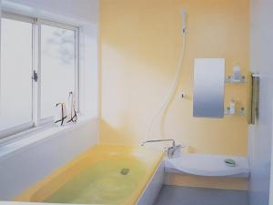 a bathroom with a tub and a sink and a toilet at Ryoshuku Lassi / Vacation STAY 47925 in Koga