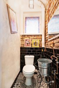 a bathroom with a toilet and a bath tub at Sunrise Republicii (Old Center) in Braşov