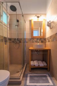 a bathroom with a shower and a sink at Yaliskari Beach in Pelekas
