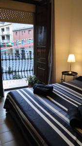 a bedroom with a bed with a view of a city at Ca La Roseta in Castellfollit de la Roca
