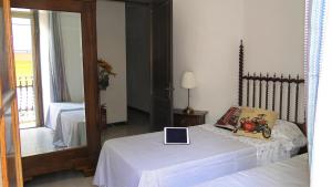 a bedroom with a bed with a laptop on it at Ca La Roseta in Castellfollit de la Roca