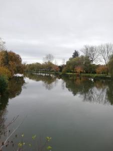 a view of a river with trees in the background at Atelier des Poèmes. in Montbéliard
