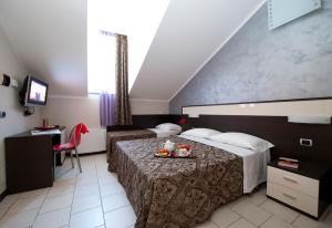Postel nebo postele na pokoji v ubytování Hotel Ideale