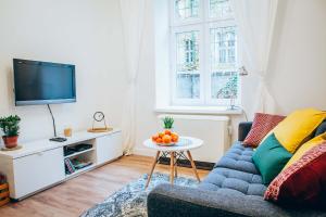 Televízia a/alebo spoločenská miestnosť v ubytovaní Cosy Apartment