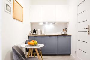 a small kitchen with a table and two chairs at Cosy Apartment in Krakow
