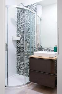 a bathroom with a shower and a sink at Cosy Apartment in Kraków