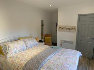 a bedroom with a bed with a colorful bedspread at The Garden room in Derry Londonderry