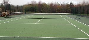 a tennis net on a tennis court at The Gatehouse at Mullans Bay in Kesh +18 photos