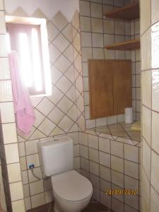 a bathroom with a white toilet and a window at Las Casitas de mi Abuela in Casares