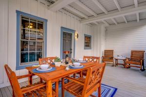 a wooden table and chairs on a porch at McKenize Guest House: Inks Suite 1 BD, 1BA in Marble Falls