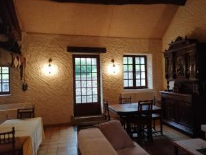 a living room with a couch and a table at Histoire d'eau in Rupt-sur-Saône