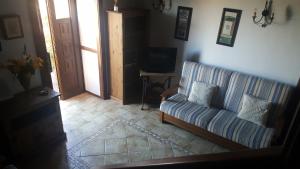a living room with a couch and a television at Apartamento El Correo in Puntallana