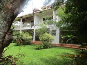a white house with a yard in front of it at Hospitality Connect in Kampala +13 photos