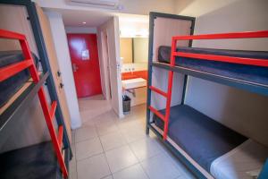 a small room with a bunk bed and a toilet at America Del Sur Hostel Buenos Aires in Buenos Aires