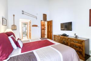 a bedroom with a large bed and a flat screen tv at Sierra Megeve in Mammoth Lakes