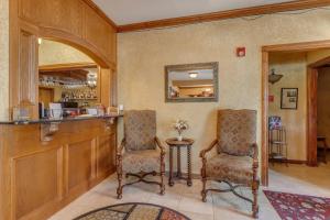 a bar with two chairs and a table in a room at The Whispering Pines Inn in Norman