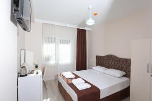Postel nebo postele na pokoji v ubytování BEKSİTİ HOTEL