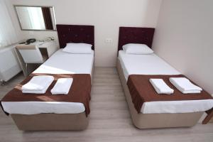 Postel nebo postele na pokoji v ubytování BEKSİTİ HOTEL