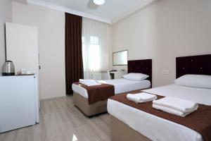 Postel nebo postele na pokoji v ubytování BEKSİTİ HOTEL