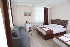 Postel nebo postele na pokoji v ubytování BEKSİTİ HOTEL
