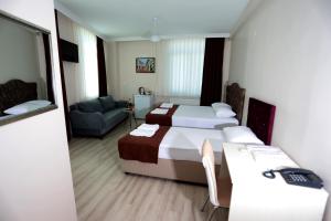 Postel nebo postele na pokoji v ubytování BEKSİTİ HOTEL