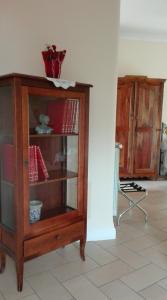 a wooden cabinet with books on it in a room at Il Portoncino in Naples