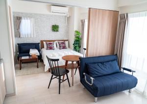 a bedroom with a bed and a table and chairs at Meet Me Umeda Nishi in Osaka