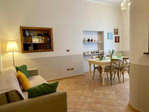 a living room with a couch and a table at A DUE PASSI temporary apartment in Trani