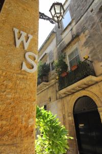 a building with a sign on the side of it at White Suite B&B in Lecce