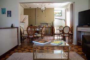 a living room with a table and chairs at Hotel Casa Branca in Uruguaiana