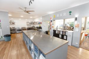 a large kitchen with a large island in the middle at Mad Monkey Village in Cairns