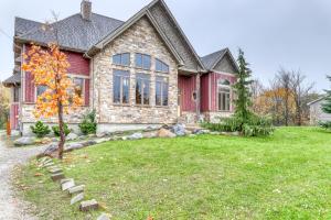 a home with a red and stone house at Lucille 109 in Blue Mountains