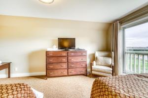 a bedroom with a dresser with a television and a window at Rivergrass 226 in Blue Mountains