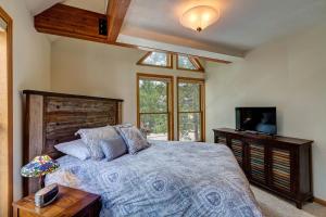 a bedroom with a large bed and a television at Silver Jacks Condo in Breckenridge