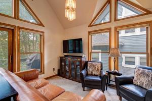 a living room with a couch and chairs and windows at Silver Jacks Condo in Breckenridge